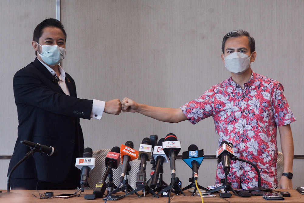 Representative of Datuk Seri Anwar Ibrahim, Fahmi Fadzil and representative of Datuk Seri Najib Razak, Isham Jalil speaks during a press conference on the Najib vs Anwar debate, Kuala Lumpur April 17, 2022. u00e2u20acu201d Picture by Miera Zulyana