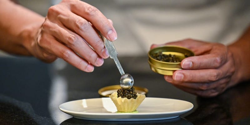 Chef Thitid u00e2u20acu02dcTonu00e2u20acu2122 Tassanakajohn making a dish using caviar from Thai Sturgeon Farm at the Lahnyai Nusara restaurant in Bangkok. u00e2u20acu201d AFP pic