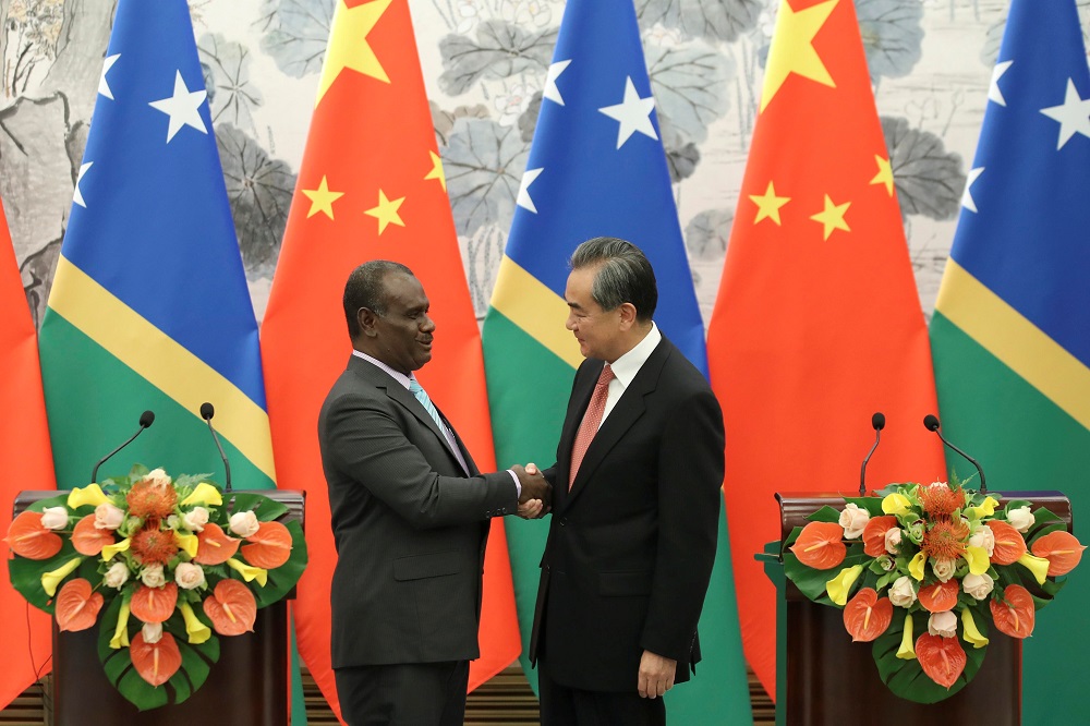 Chinese State Councillor and Foreign Minister Wang Yi shakes hands with Solomon Islands Foreign Minister Jeremiah Manele at the Diaoyutai State Guesthouse in Beijing September 21, 2019. u00e2u20acu201d Picture by Sheng Jiapeng/CNS via Reuters