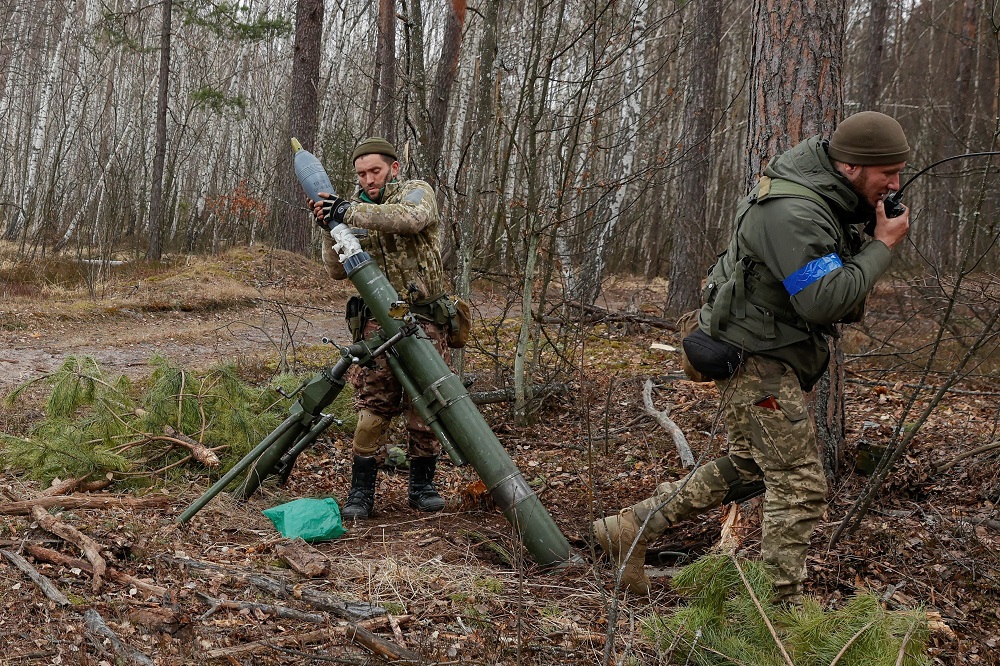 A Ukrainian serviceman fires with a mortar, as Russia’s attack on Ukraine continues, at a position in Kyiv region, Ukraine March 30, 2022. — Reuters pic