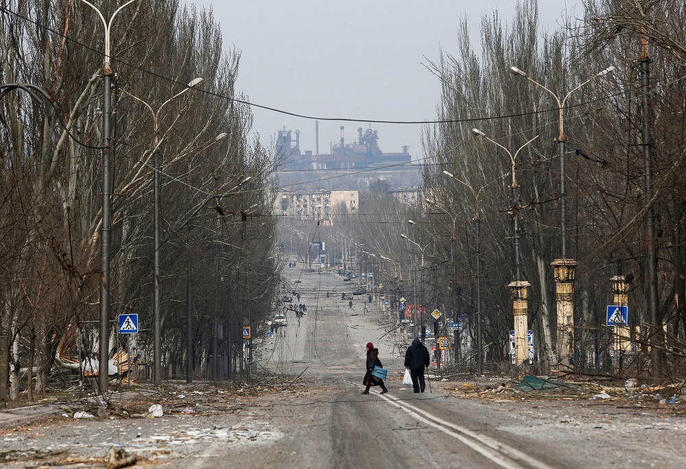 Local residents walk along a street damaged during Ukraine-Russia conflict in the besieged southern port city of Mariupol March 31, 2022. u00e2u20acu201d Reuters pic