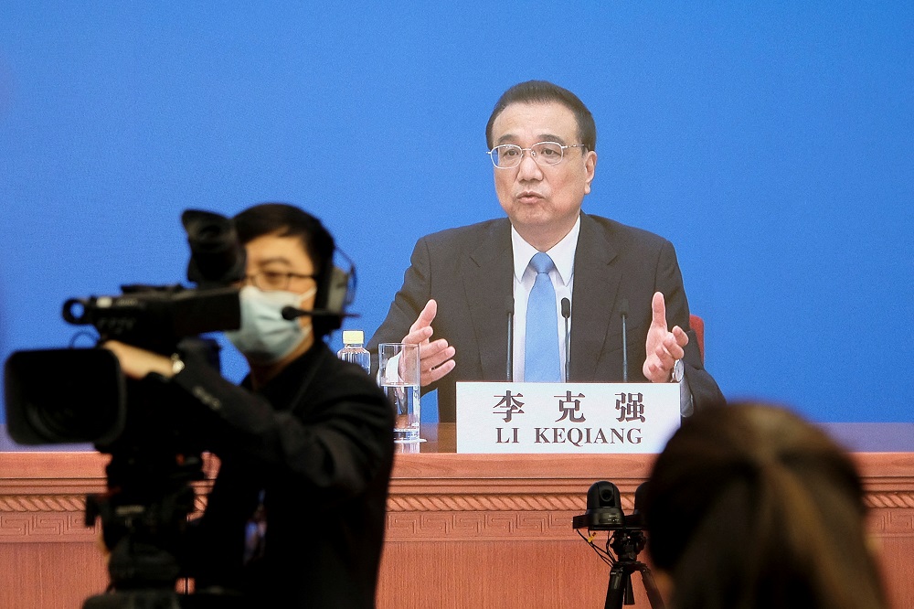 Chinese Premier Li Keqiang is seen on a screen as he attends a news conference via video link after the closing session of the National People's Congress in Beijing March 11, 2022. u00e2u20acu201d Reuters pic