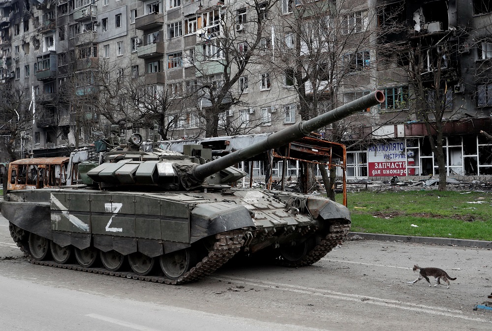 A cat walks next to a tank of pro-Russian troops in front of an apartment building damaged during Ukraine-Russia conflict in the southern port city of Mariupol, Ukraine April 19, 2022. u00e2u20acu201d Reuters pic