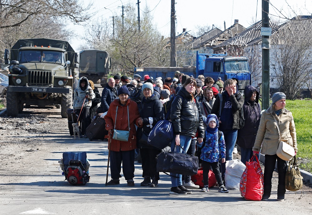 Evacuees wait before boarding a bus to leave the city during Ukraine-Russia conflict in the southern port of Mariupol, Ukraine April 20, 2022. — Reuters pic