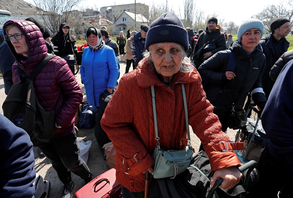 Evacuees wait before boarding a bus to leave the city during Ukraine-Russia conflict in the southern port of Mariupol, Ukraine April 20, 2022. — Reuters pic