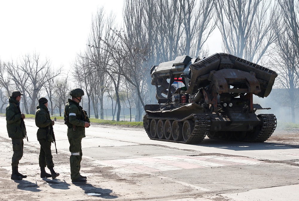 Service members of pro-Russian troops stand next to a combat engineering vehicle, as evacuees board buses to leave the city during Ukraine-Russia conflict in the southern port of Mariupol, Ukraine April 20, 2022. u00e2u20acu201d Reuters pic