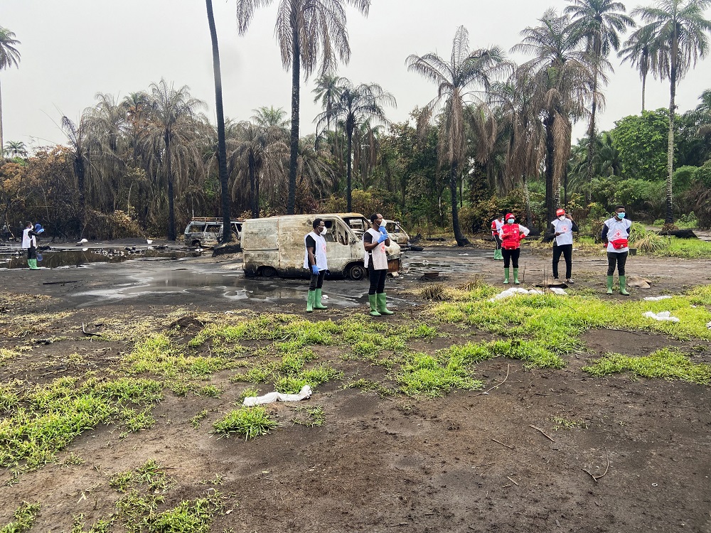 Members of the Nigeria Red Cross stand at the scene of explosion in which over 100 people lost their lives, at an illegal crude oil bunkering site at Abaezi forest, in Ohaji-Egbema Local Government Area of Imo state, Nigeria April 24, 2022. u00e2u20acu201d Reuters pi