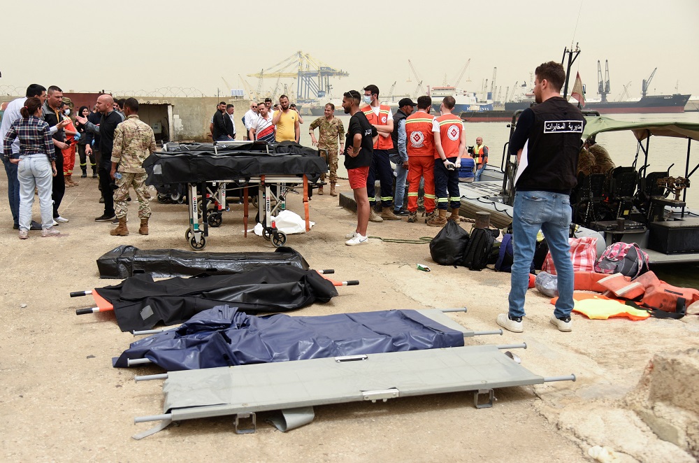 People stand near stretchers that are prepared for dead bodies after a boat capsized off the Lebanese coast of Tripoli overnight, at port of Tripoli, northern Lebanon April 24, 2022. u00e2u20acu201d Reuters pic