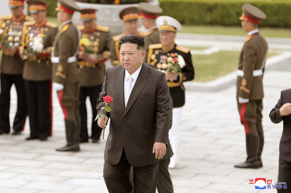 North Korean leader Kim Jong-un walks with a rose in his hand to place it at the Revolutionary Martyrs Cemetery on Mount Daesong in Pyongyang in this undated photo released on April 26, 2022. u00e2u20acu201d Picture by KCNA via Reuters