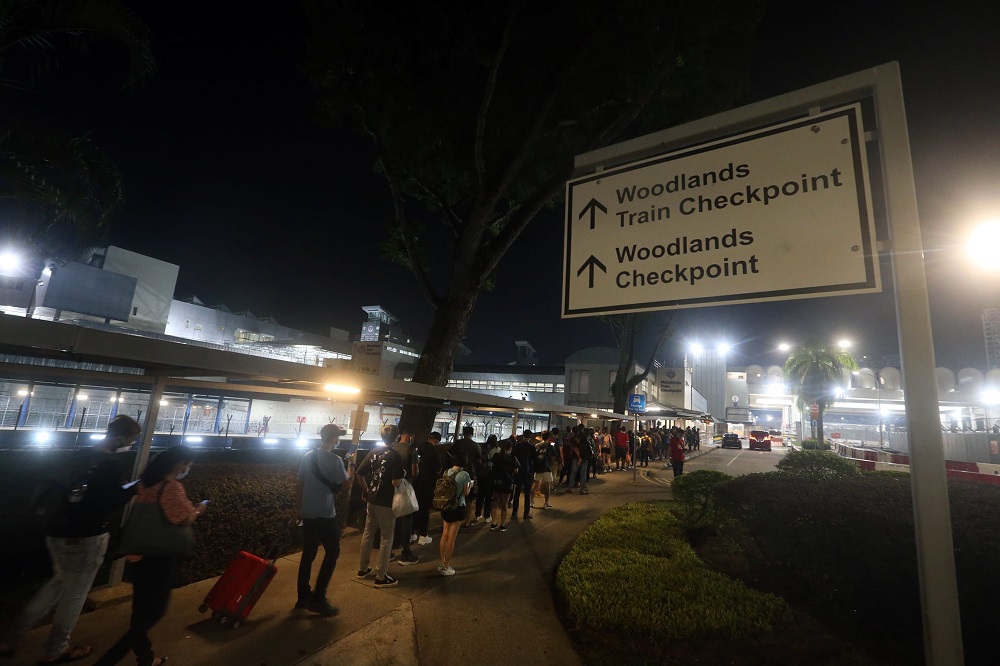 The scenes at Woodlands Checkpoint in Singapore as people head towards Johor Baru, Malaysia on the first day land borders are fully reopened past midnight on April 1, 2022. — TODAY pic