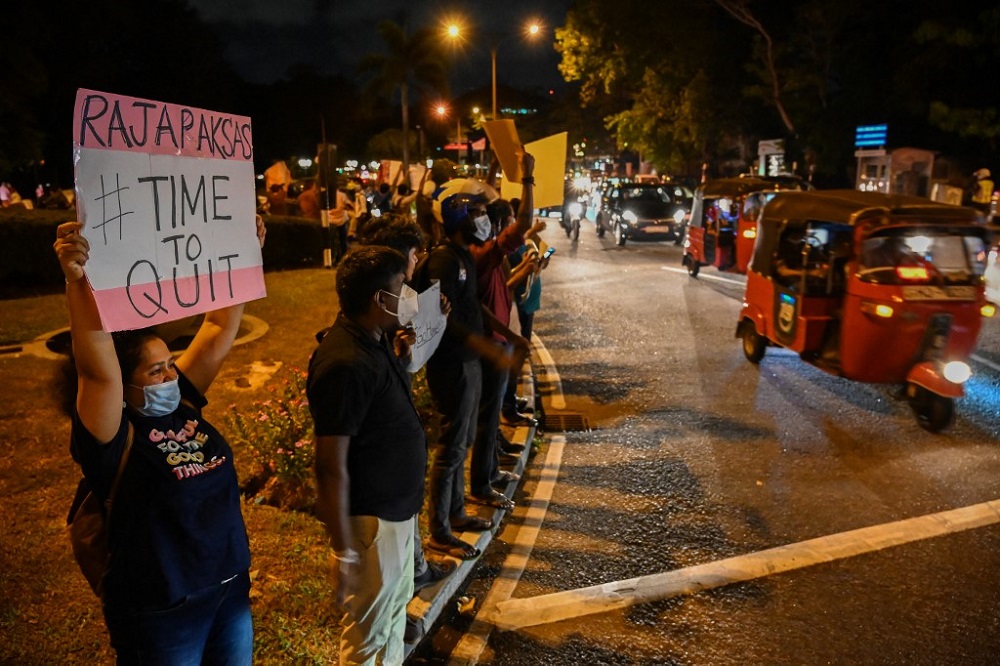 Protestors hold banners and placards during a demonstration against the surge in prices and shortage of fuel and other essential commodities in Colombo April 1, 2022. u00e2u20acu201d AFP pic