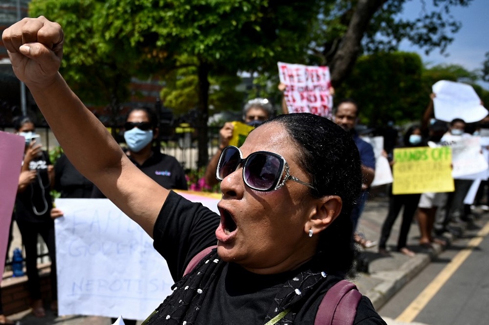 Protestors hold banners and placards during a demonstration against the surge in prices and shortage of fuel and other essential commodities in Colombo April 4, 2022. u00e2u20acu201d AFP pic