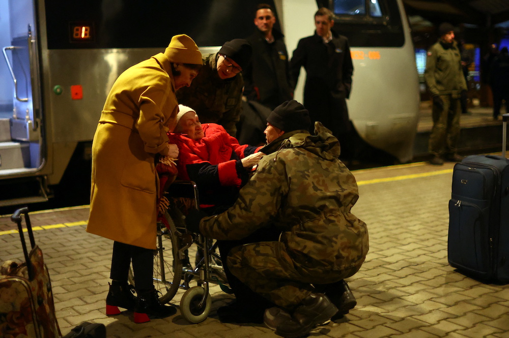 Polish soldiers help a Ukrainian refugee off train from Ukraine, at Przemysl Glowny train station, after fleeing the Russian invasion of Ukraine, in Przemysl, Poland, April 3, 2022. u00e2u20acu201d Reuters pic