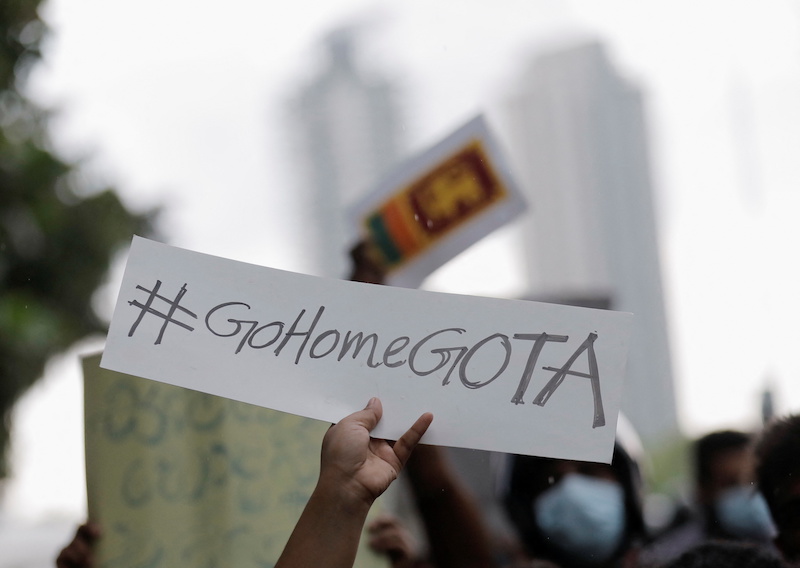 A person holds a placard demanding Sri Lanka's President Gotabaya Rajapaksa to resign after his government lost its majority in the parliament, during a protest in Colombo, Sri Lanka, April 5, 2022. u00e2u20acu201d Reuters picnn
