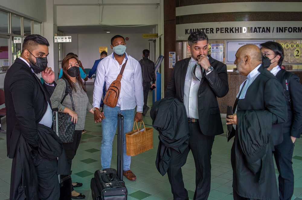 Simon Momoh (third left) with his wife (second left) and team of lawyers after the hearing at the Shah Alam Court on April 11,2022. 
