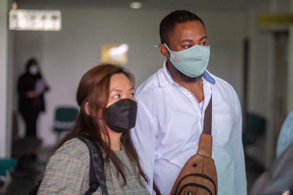 Simon Momoh (right) and his wife Low Kar Hui at the Shah Alam Court complex April 11, 2022. u00e2u20acu201d Picture by Shafwan Zaidon