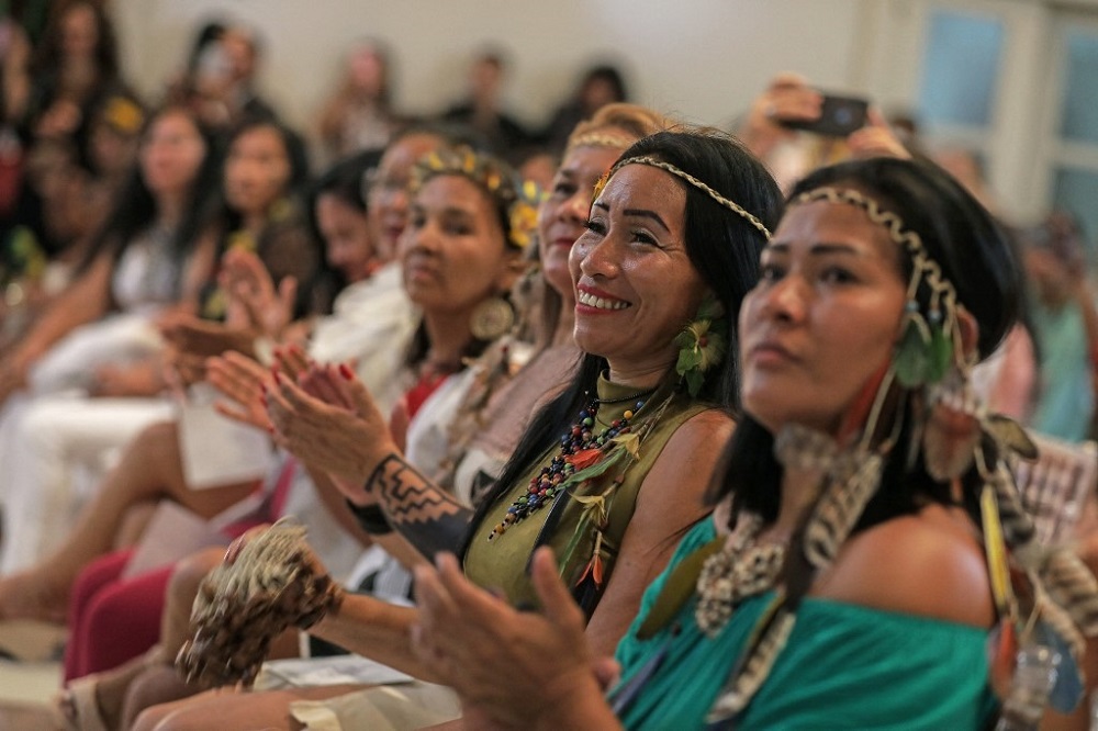 Indigenous women watch indigenous models on the catwalk during a fashion event in Manaus, Amazon on April 9, 2022. — AFP pic