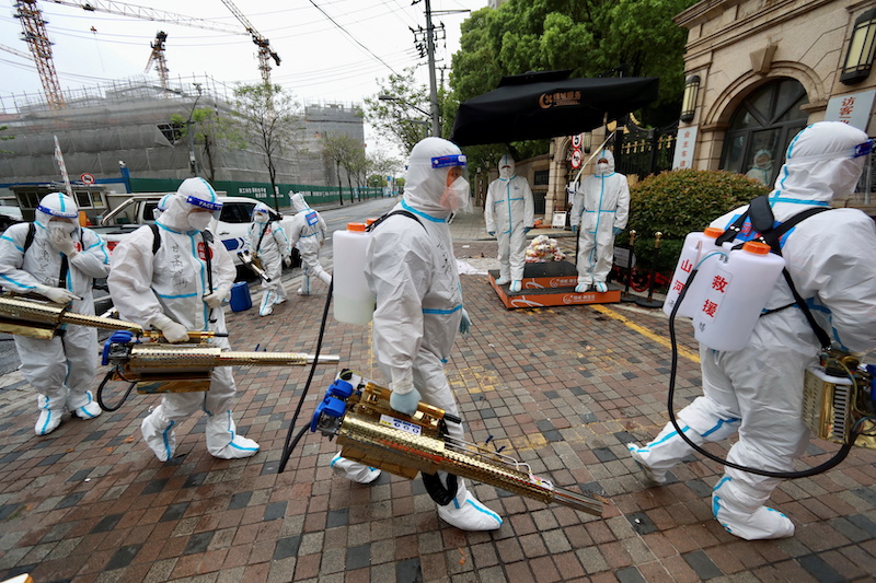 Volunteers in protective suits prepare to disinfect a residential compound in Huangpu district, to curb the spread of the coronavirus disease (Covd-19), in Shanghai, China April 14, 2022. u00e2u20acu201d China Daily via Reuters pic