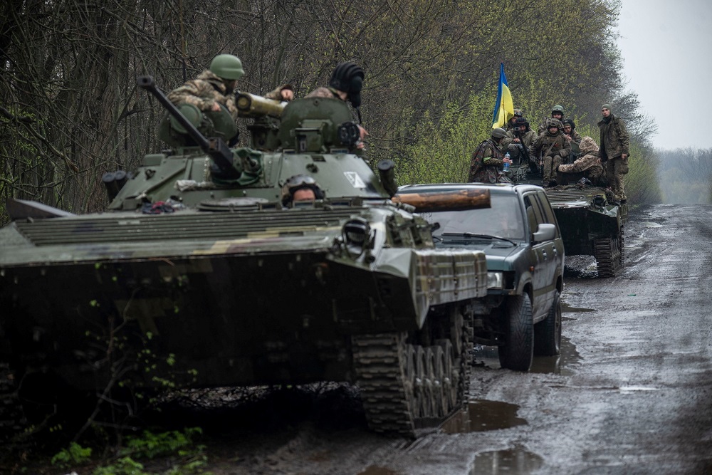 Ukrainian servicemen sit atop an armoured fighting vehicle, as Russia?s attack on Ukraine continues, at an unknown location in Eastern Ukraine April 19, 2022. u00e2u20acu201d Picture by press service of the Ukrainian Ground Forces/Handout via Reuters