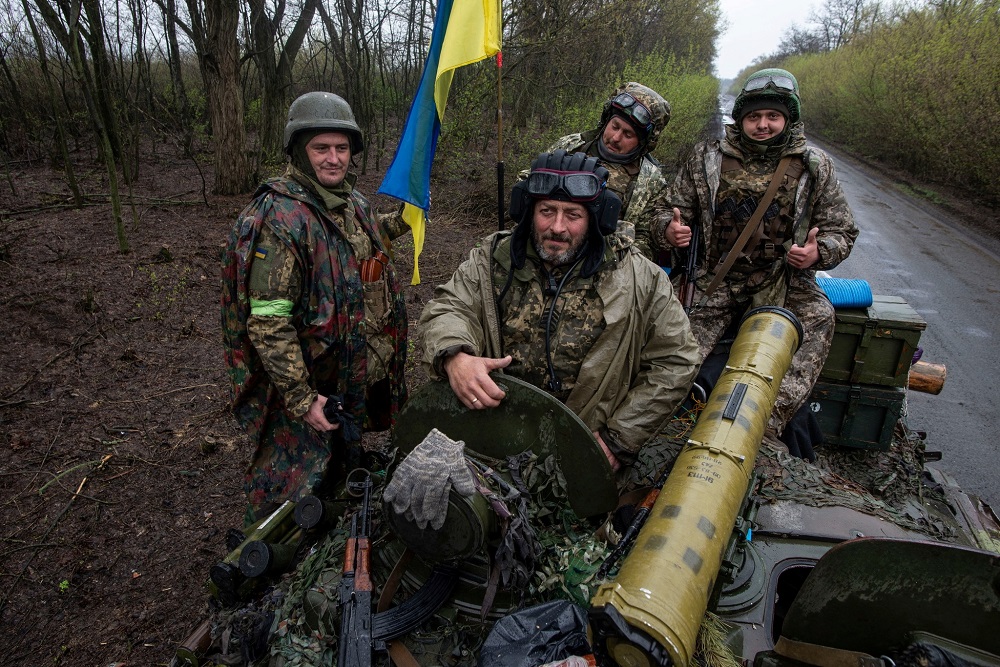 Ukrainian servicemen sit atop an armoured fighting vehicle, as Russia?s attack on Ukraine continues, at an unknown location in Eastern Ukraine April 19, 2022. u00e2u20acu201d Picture by press service of the Ukrainian Ground Forces/Handout via Reuters
