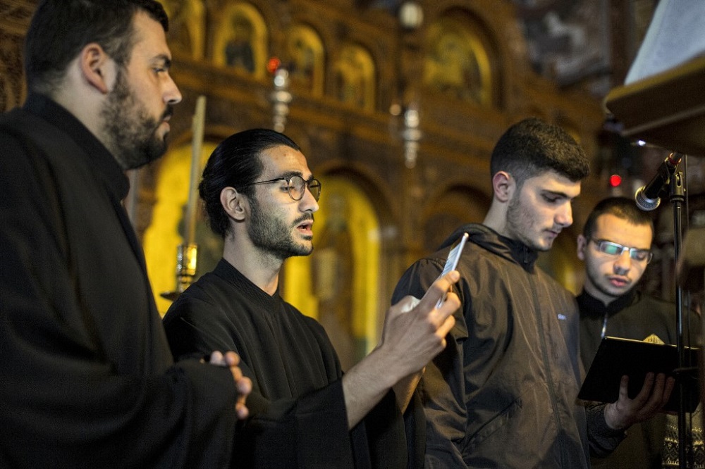 Members of the Cypriot Melodists Byzantine choir read off a tablet showing the Byzantine chant notation as they chant at the Greek Orthodox Church of Ayia Napa (Panagia Church) in Cyprusu00e2u20acu2122 eastern coastal city of Ayia Napa April 10, 2022. u00e2u20acu201d AFP pic