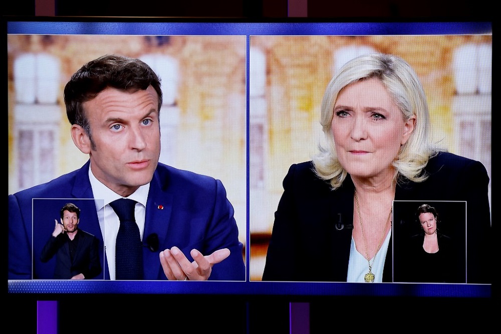 A picture shows a TV screen displaying a live televised between Emmanuel Macron (left) and Marine Le Pen, in Saint-Denis, north of Paris April 20, 2022. u00e2u20acu201d AFP pic