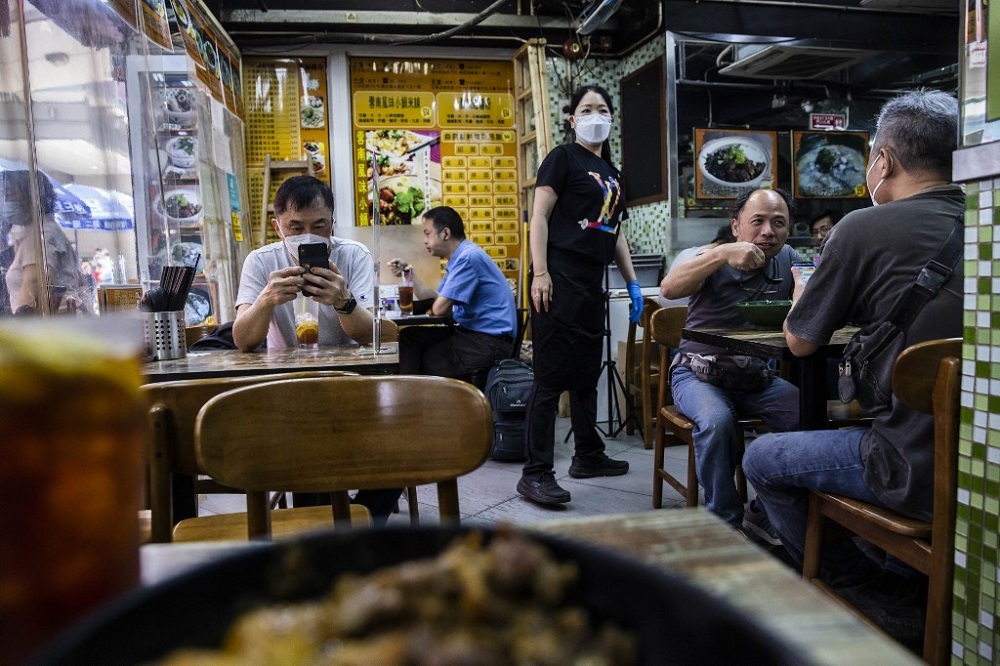Customers dine at a restaurant in Hong Kong on April 14, 2022, as the Hong Kong government announces the easing of strict Covid-19 restrictions on April 21. u00e2u20acu201d AFP pic