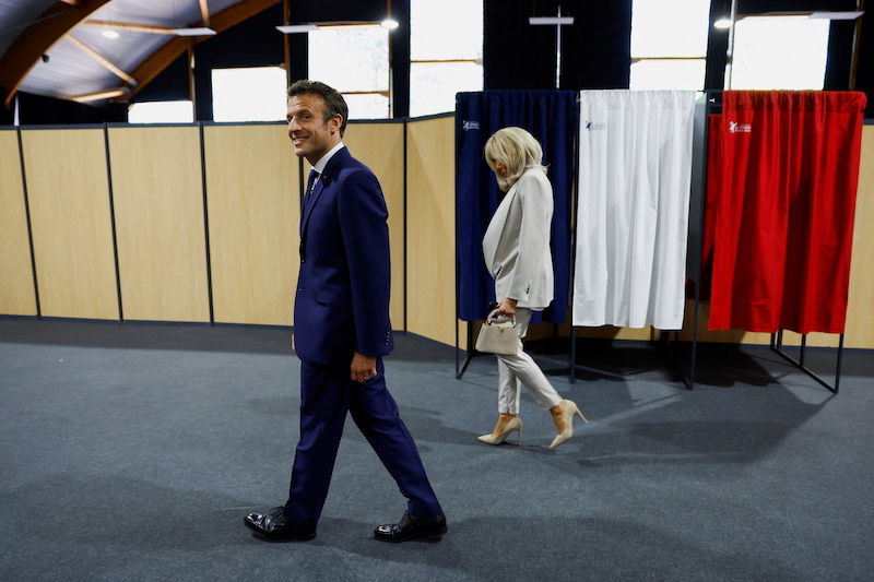 French President Emmanuel Macron and his wife Brigitte Macron arrive to vote in the second round of the 2022 French presidential election, at a polling station in Le Touquet-Paris-Plage, France, April 24, 2022. u00e2u20acu201d Reuters pi
