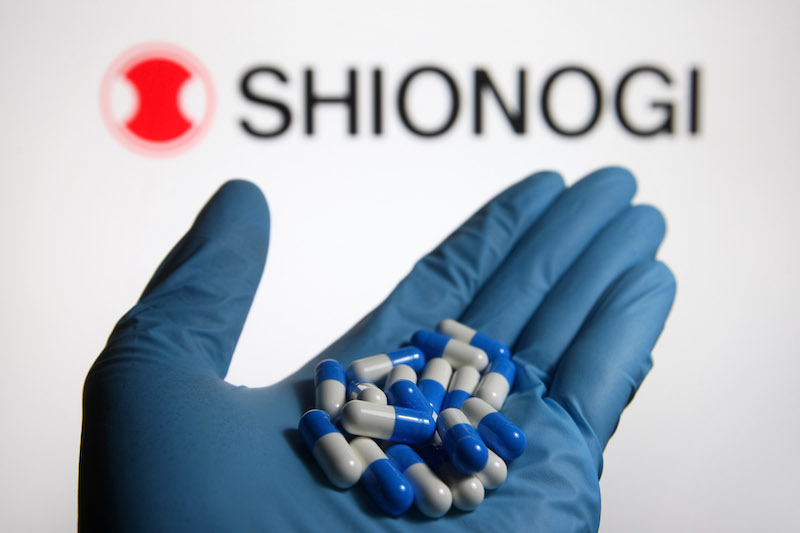 In this photo illustration, medicine pills are seen in a hand dressed in a medical glove with a Shionogi & Co., Ltd. logo of an Japanese pharmaceutical company in the background. u00e2u20acu201d SOPA Images/Sipa USA via Reuters nn