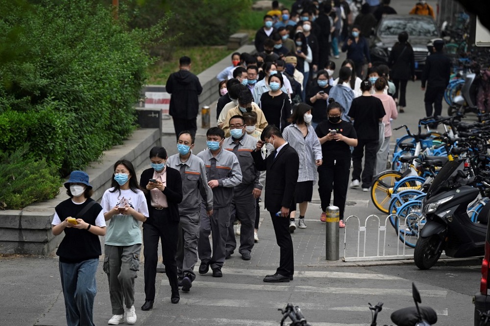 People wait in line to be tested for the Covid-19 coronavirus at a swab collection site in Beijing April 25, 2022. u00e2u20acu201d AFP pic