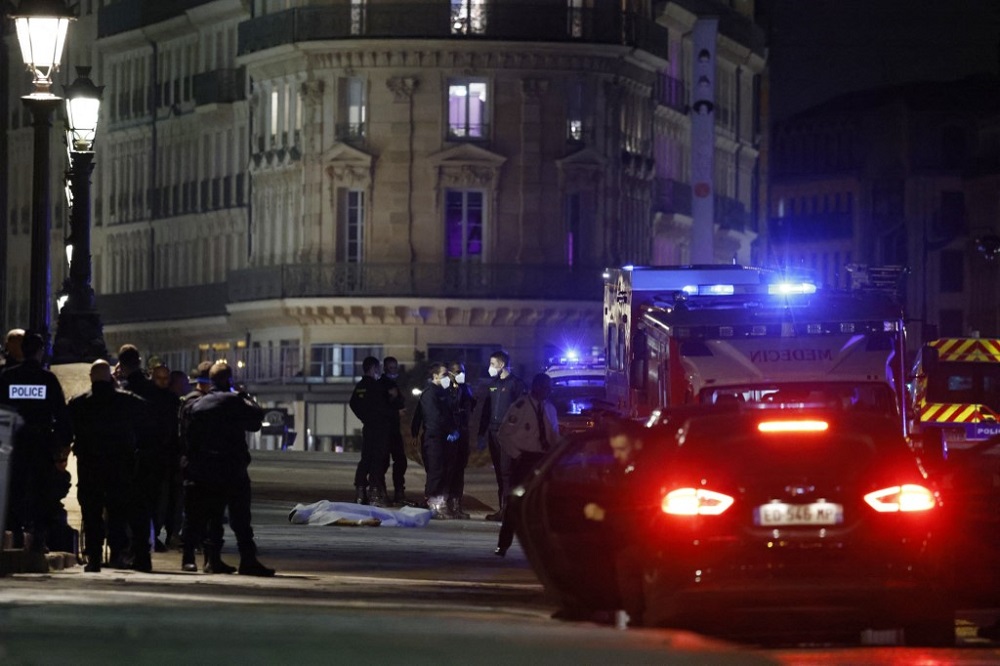Police officers investigates the body of one of two people shot by police in Paris April 25, 2022. u00e2u20acu201d AFP pic