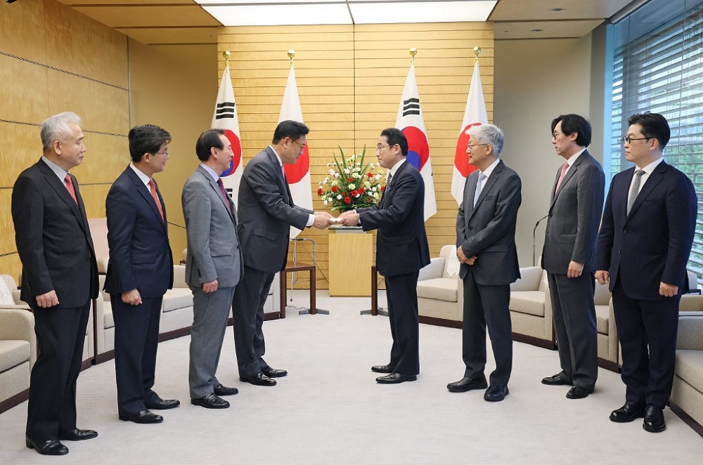 Japanese Prime Minister Fumio Kishida (fourth right) receives a letter from Chung Jin-suk (fouth left) at the prime ministeru00e2u20acu2122s office in Tokyo April 26, 2022. u00e2u20acu201d nHandout by Japanu00e2u20acu2122s Cabinet Public Relations Office via Jiji Press / AFPn