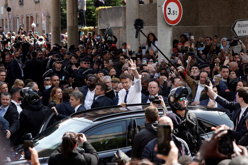 French President Emmanuel Macron waves from his car as he leaves after a visit to meet residents at the Saint-Christophe market square in Cergy, Paris suburb, as part of his first trip after being re-elected president, France, April 27, 2022. u00e2u20acu201d Reuters 
