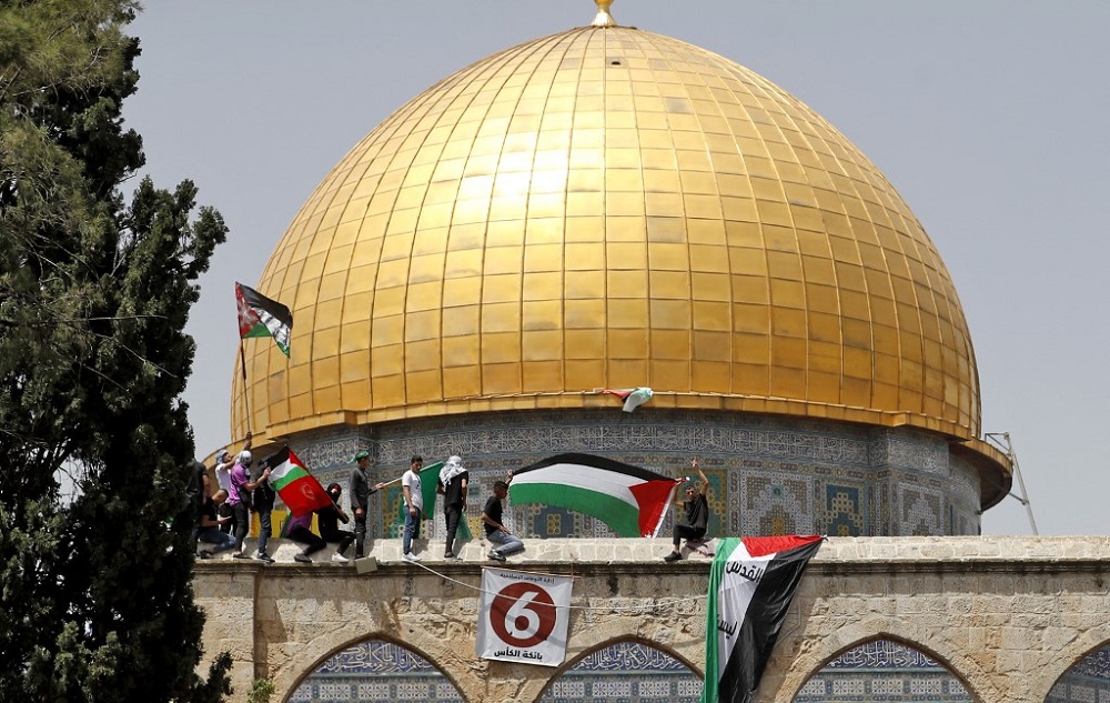 Palestinian protesters wave Palestinian and Islamic flags as they rally by the Dome of the Rock mosque at the Al-Aqsa Mosque complex in Jerusalem, following the last Friday prayers of the Muslim holy month of Ramadan April 29, 2022. u00e2u20acu201d AFP pic