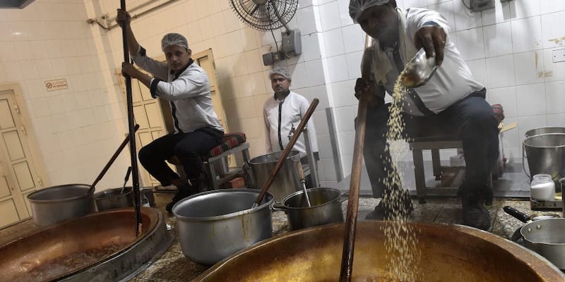 Workers prepare Halwa, a Bahraini sweet made primarily from sugar, corn starch, saffron and nuts at Hussain Showaiter Sweets at the Muharraq island store in northern Bahrain. u00e2u20acu201d AFP pic