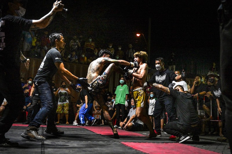 Combatants compete in Muay Thai at an event by Fight Club Thailand, an underground organisation that hosts unsanctioned fights of various martial arts disciplines, in a parking lot in the Klong Toey district of Bangkok. u00e2u20acu201d AFP pic                