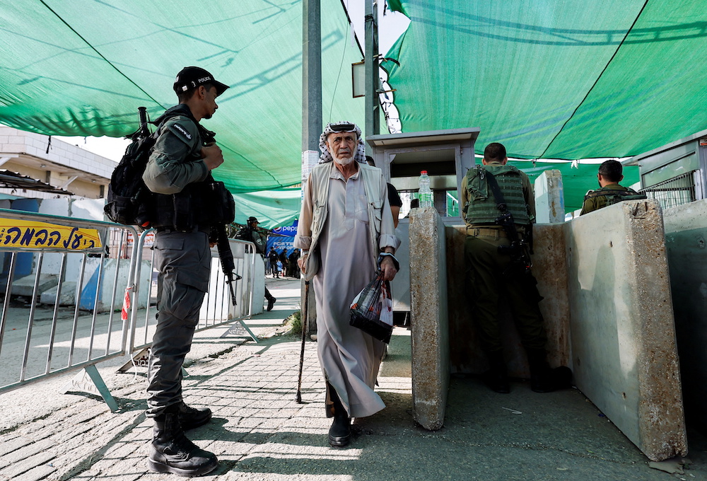 An elder Palestinian man makes his way through an Israeli checkpoint to attend the last Friday prayers of Ramadan in Jerusalem's Al-Aqsa mosque, in Bethlehem in the Israeli-occupied West Bank April 29, 2022. u00e2u20acu201d Reuters