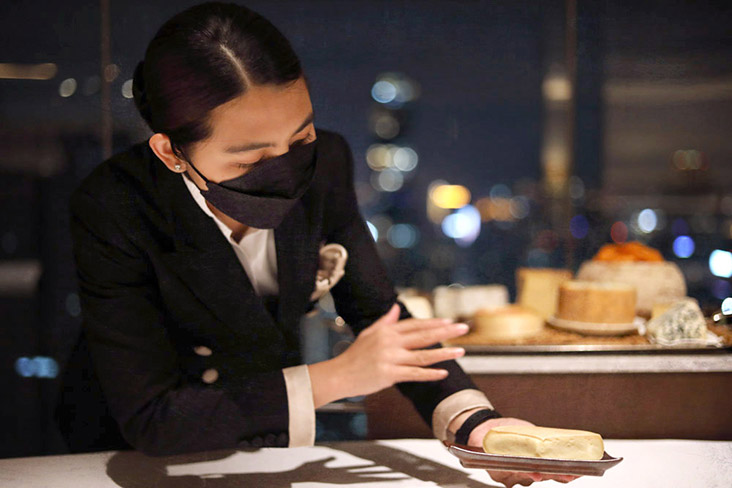 Khun Gene carefully explains every cheese that they have selected.