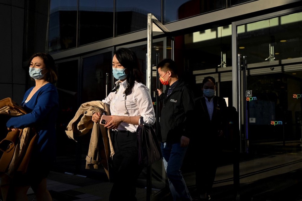 People walk out of a mall in Beijing on April 15, 2022. u00e2u20acu201d AFP pic