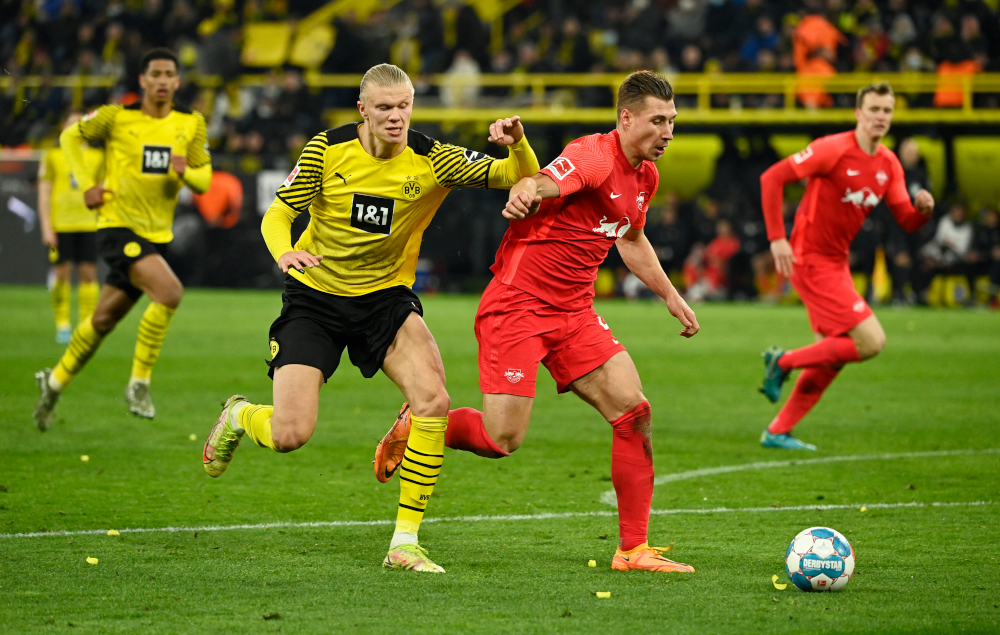 Dortmund forward Erling Haaland and Leipzig defender Willi Orban vie for the ball during the German first division Bundesliga match in Dortmund, western Germany, April 2, 2022. u00e2u20acu201d AFP pic 