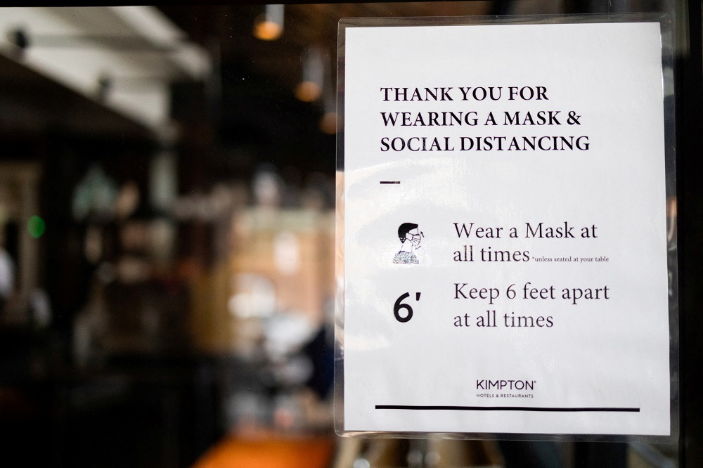 A sign is seen at a dining area that has been modified to prevent the spread of Covid-19 at the Kimpton Hotel Monaco in Philadelphia, Pennsylvania April 7, 2021. u00e2u20acu2022 Reuters file pic