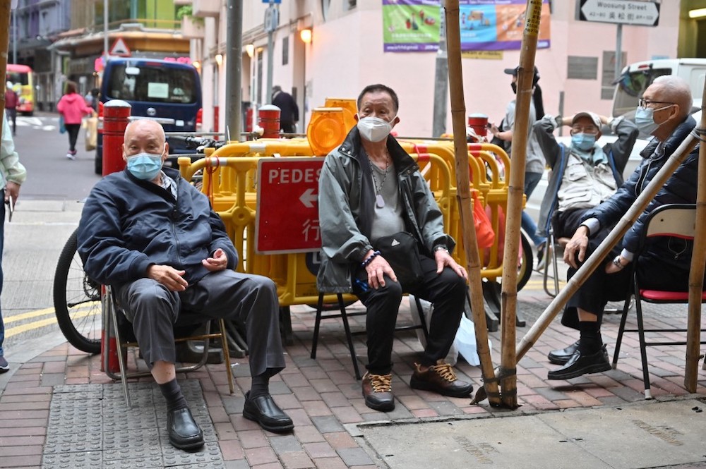 Men hang out on a street in Hong Kong on March 29, 2022. u00e2u20acu201d AFP pic