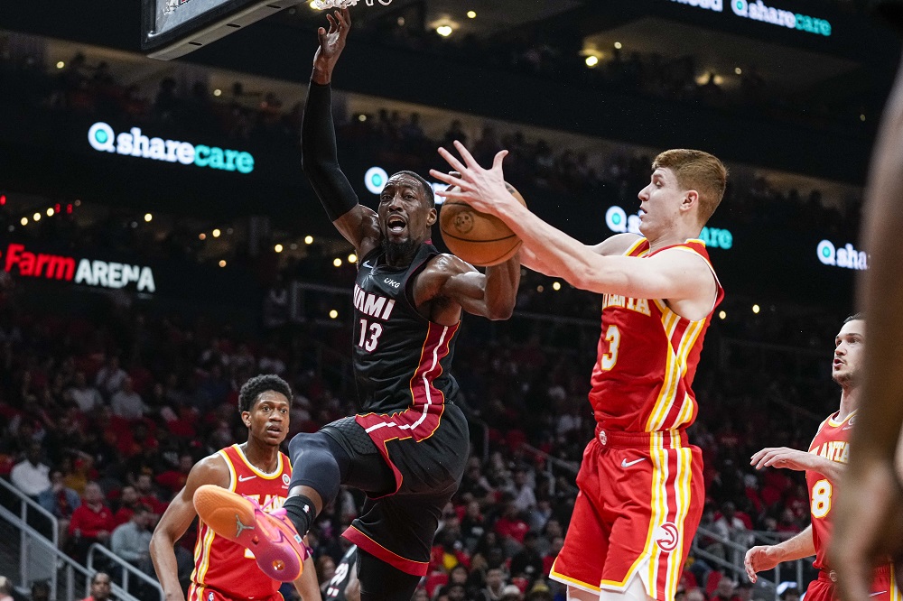 Miami Heat centre Bam Adebayo (13) loses the ball to Atlanta Hawks guard Kevin Huerter (3) on his way to the basket during the 2022 NBA playoffs at State Farm Arena. u00e2u20acu2022 Dale Zanine-USA TODAY Sports via Reuters