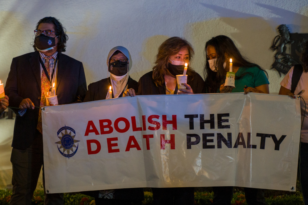 The vigil began at 8.30pm when around 40 people walked from the side entrance of the embassy holding makeshift candle holders made out of plastic cups. — Picture By Devan Manuel