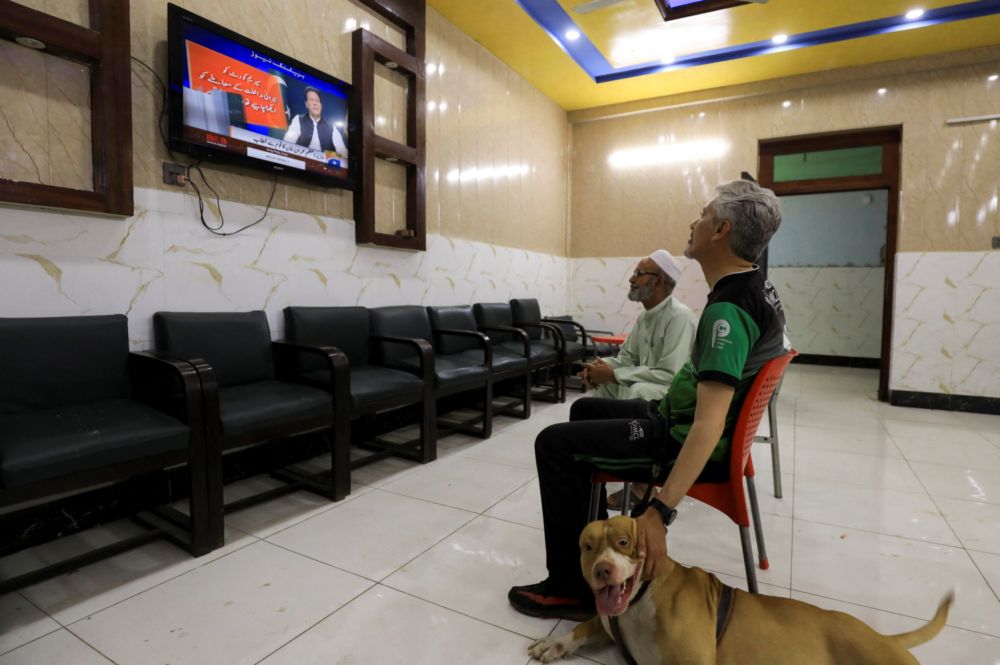 People watch the speech of Pakistani Prime Minister Imran Khan on a television screen, in Peshawar, Pakistan, April 8, 2022. u00e2u20acu201d Reuters pic