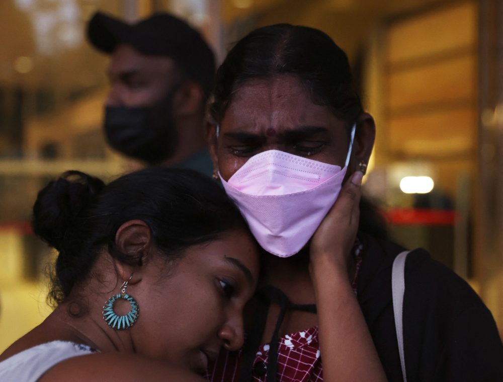 Panchalai Supermaniam (centre), mother of Malaysian drug trafficker on death row Nagaenthran Dharmalingam, leaves the Supreme Court after her last-ditch challenge was dismissed, in Singapore April 26, 2022. — Reuters pic 