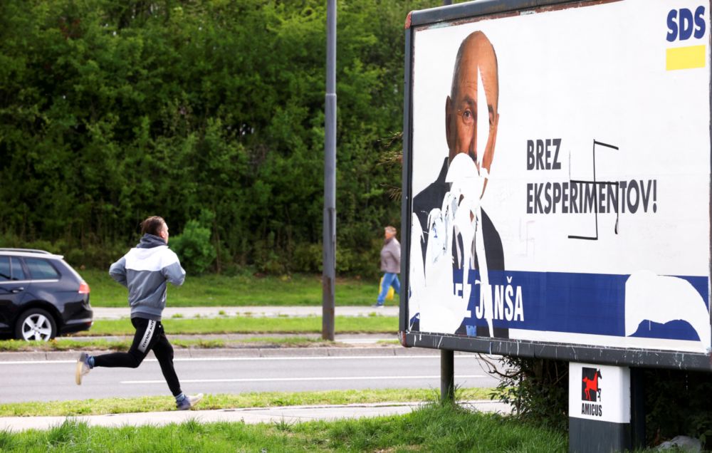 A man walks next to a billboard showing Slovenian Prime minister and candidate to parliamentary elections Janez Jansa during the early voting ahead of the upcoming parliamentary election, in Ljubljana, Slovenia, April 19, 2022. u00e2u20acu201d Reuters pic
