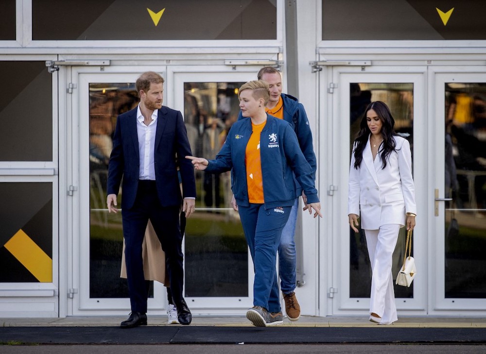 Britainu00e2u20acu2122s Duke of Sussex Prince Harry (left) and his wife Duchess of Sussex Meghan (right) walk with officials on the yellow carpet ahead of The Invictus Games in The Hague on April 15, 2022. u00e2u20acu201d AFP pic