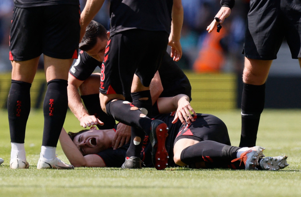 Southamptonu00e2u20acu2122s Tino Livramento goes down after sustaining an injury as Shane Long looks on during a match against Brighton & Hove Albion at The American Express Community Stadium, Brighton, Britain, April 24, 2022. u00e2u20acu201d Action Images via Reuters