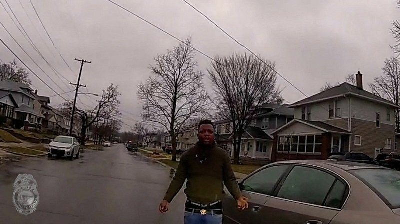 Patrick Lyoya stands near a car during a traffic stop, shortly before he was shot dead by a Grand Rapids Police officer during a scuffle on a suburban front lawn in Grand Rapids, Michigan April 4, 2022 in a still image from police body camera video. u00e2u20acu2022 G